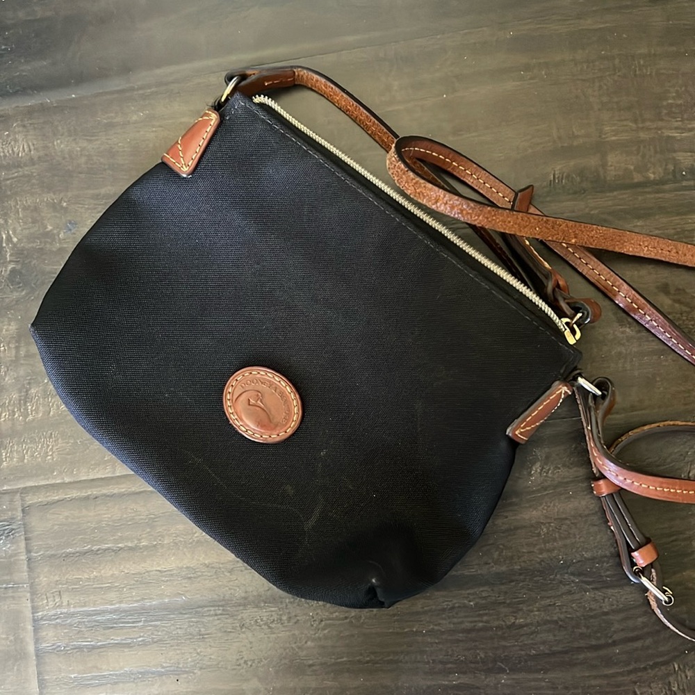 Dooney & Bourkey Cross Body bag , canvas made with leather adjustable straps